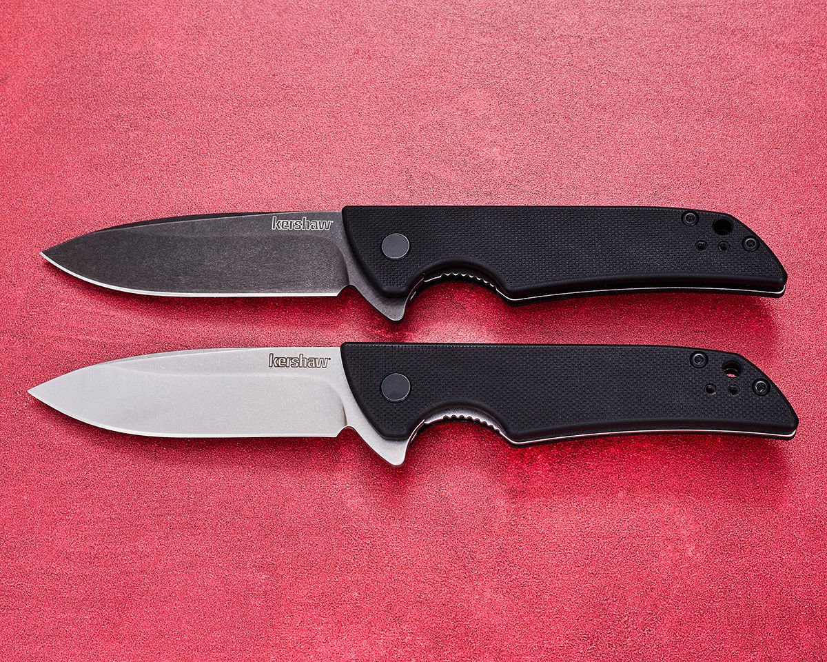 Two Kershaw Skyline folding knives open on red background